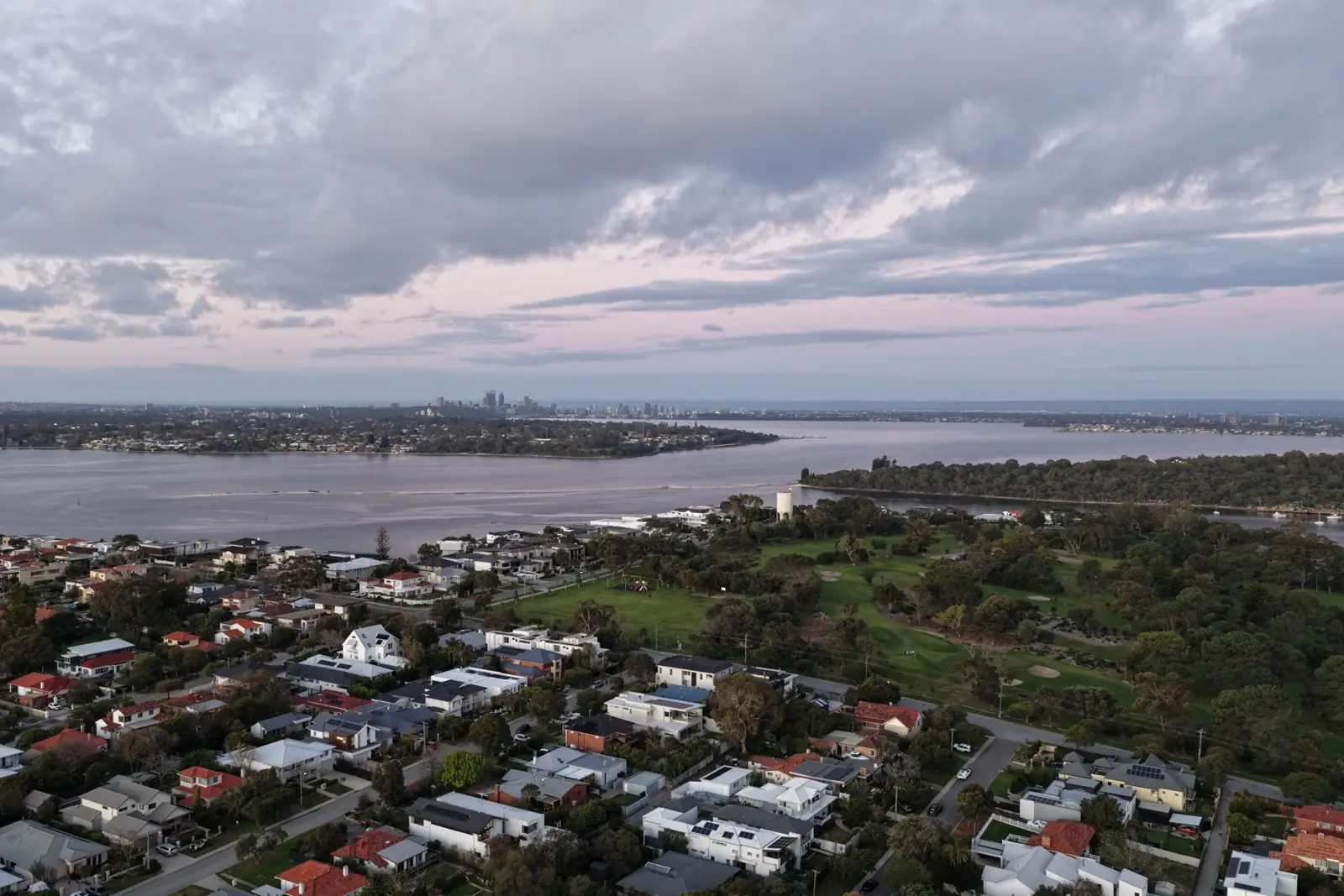 A wide view over the river and Mosman Park at dusk